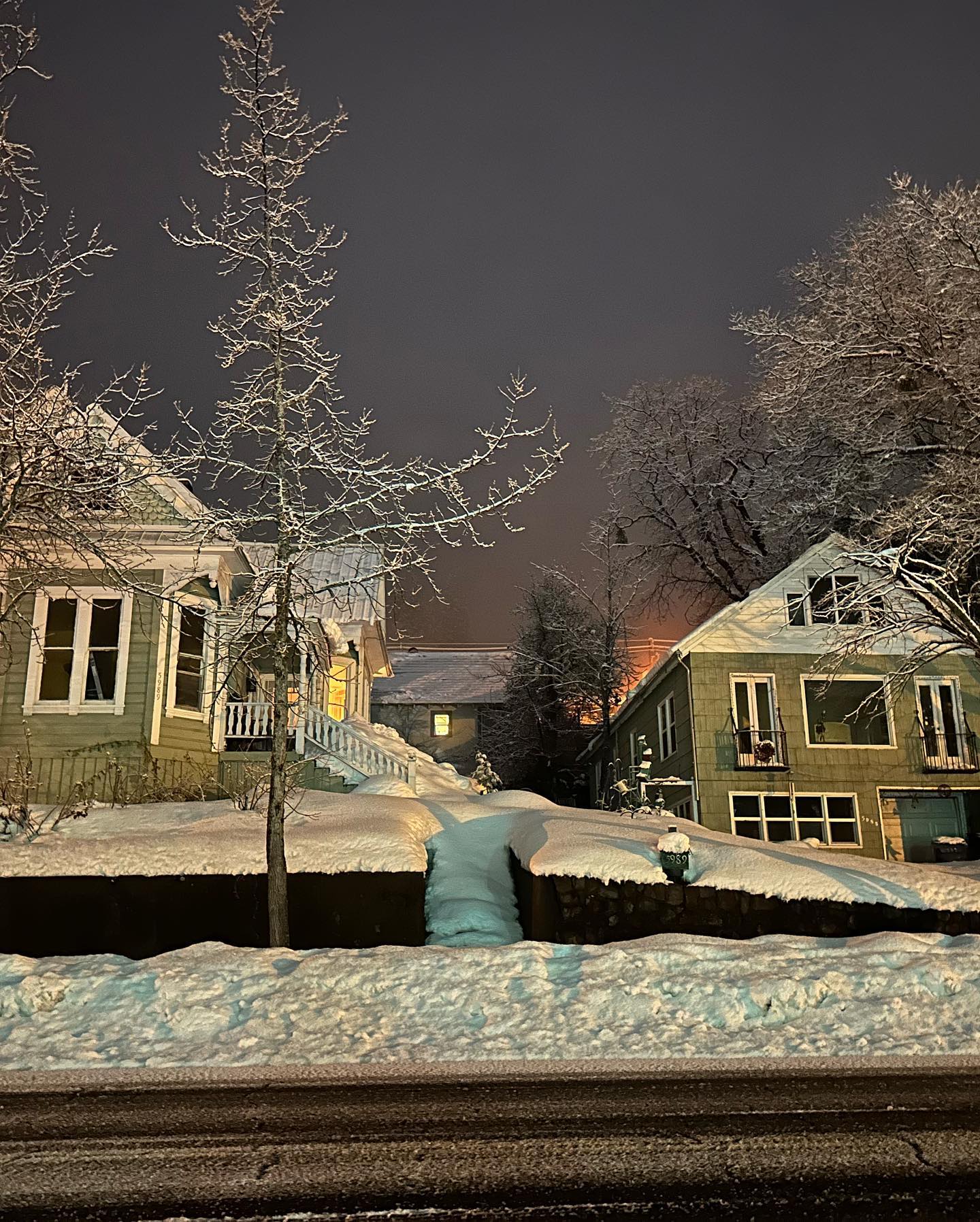 Snow-covered houses at night